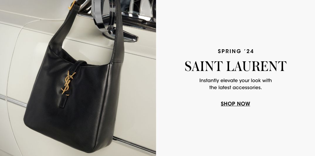 1 photo, of a large black Saint Laurent leather handbag hanging from the side mirror of a cream car.